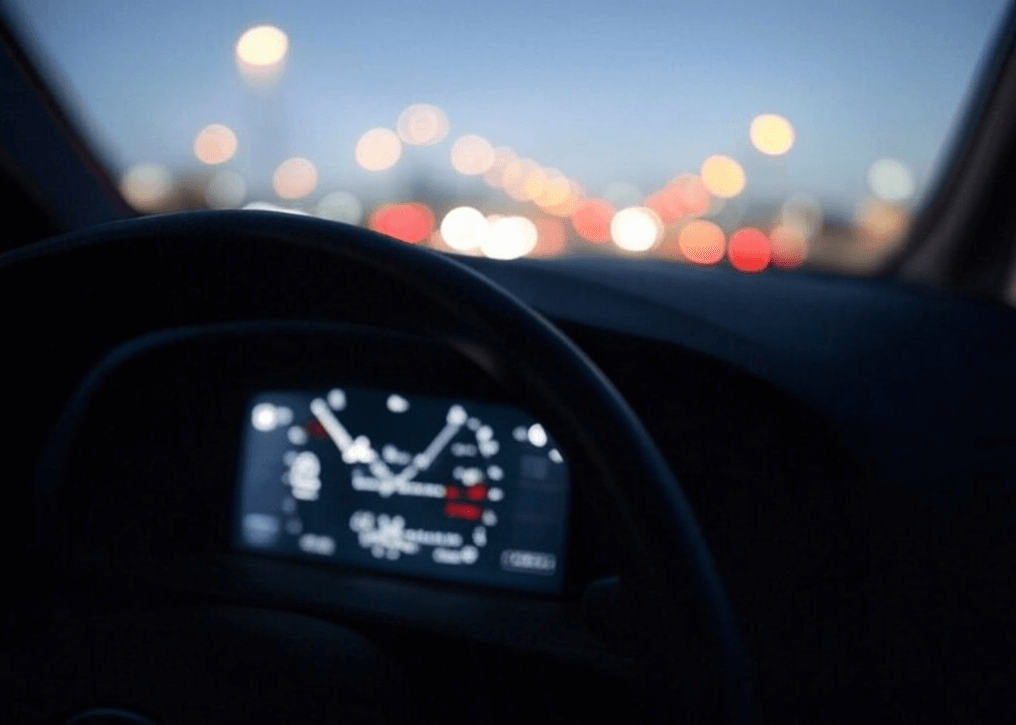 Car dashboard showing fluctuating engine temperature, indicating potential water pump issues